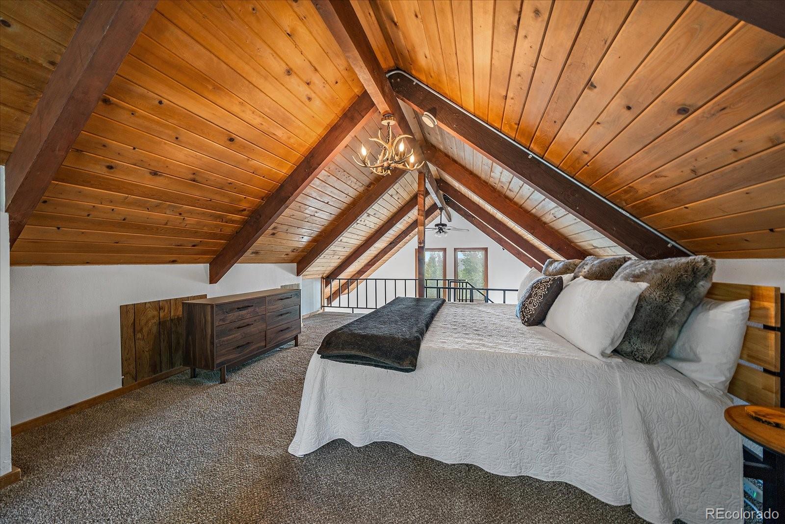 136 Nebraska Drive Idaho Springs, CO 80452 - Photo 14 of 29 a bedroom with a bed next to a window