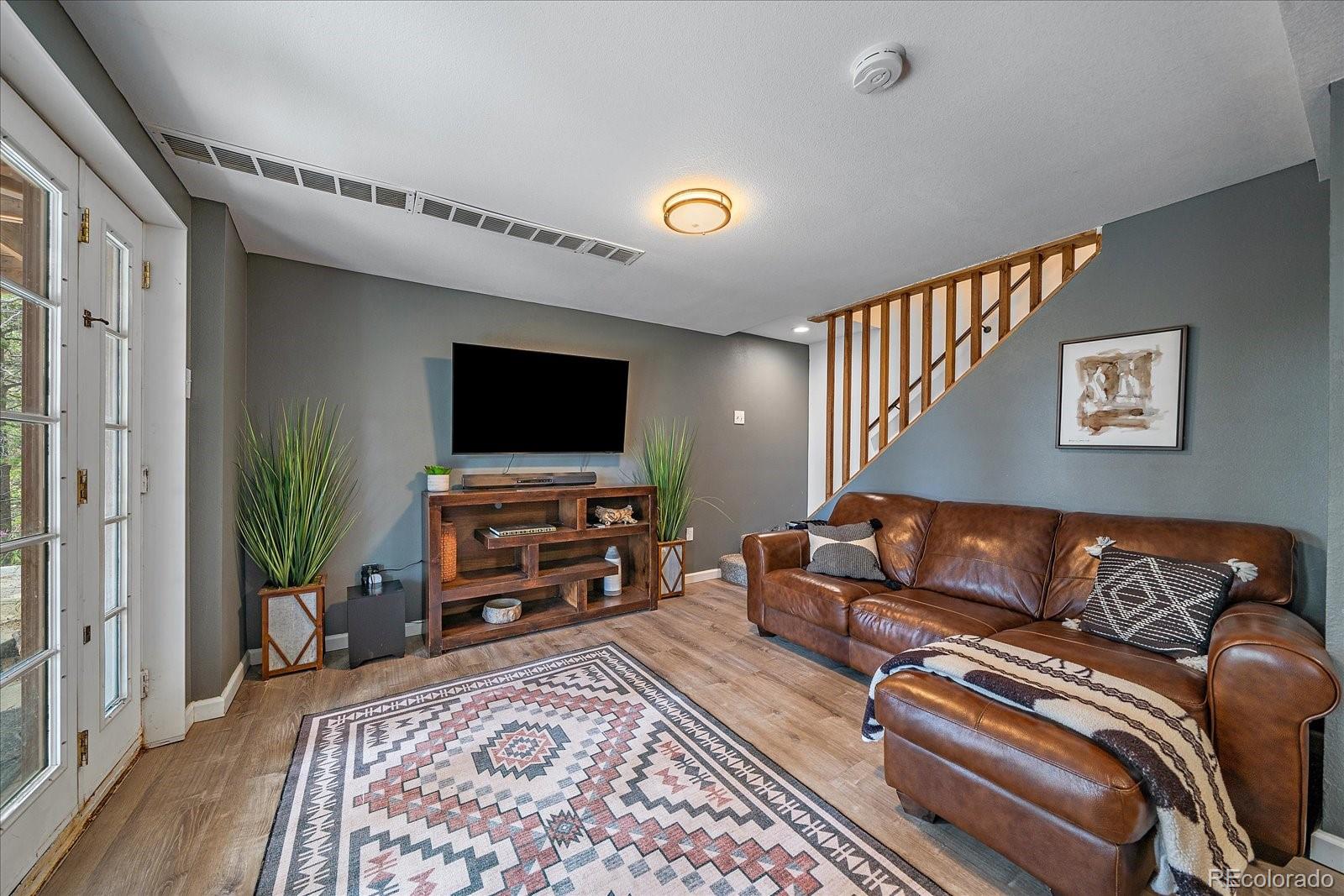 136 Nebraska Drive Idaho Springs, CO 80452 - Photo 20 of 29 a living room with furniture and a flat screen tv