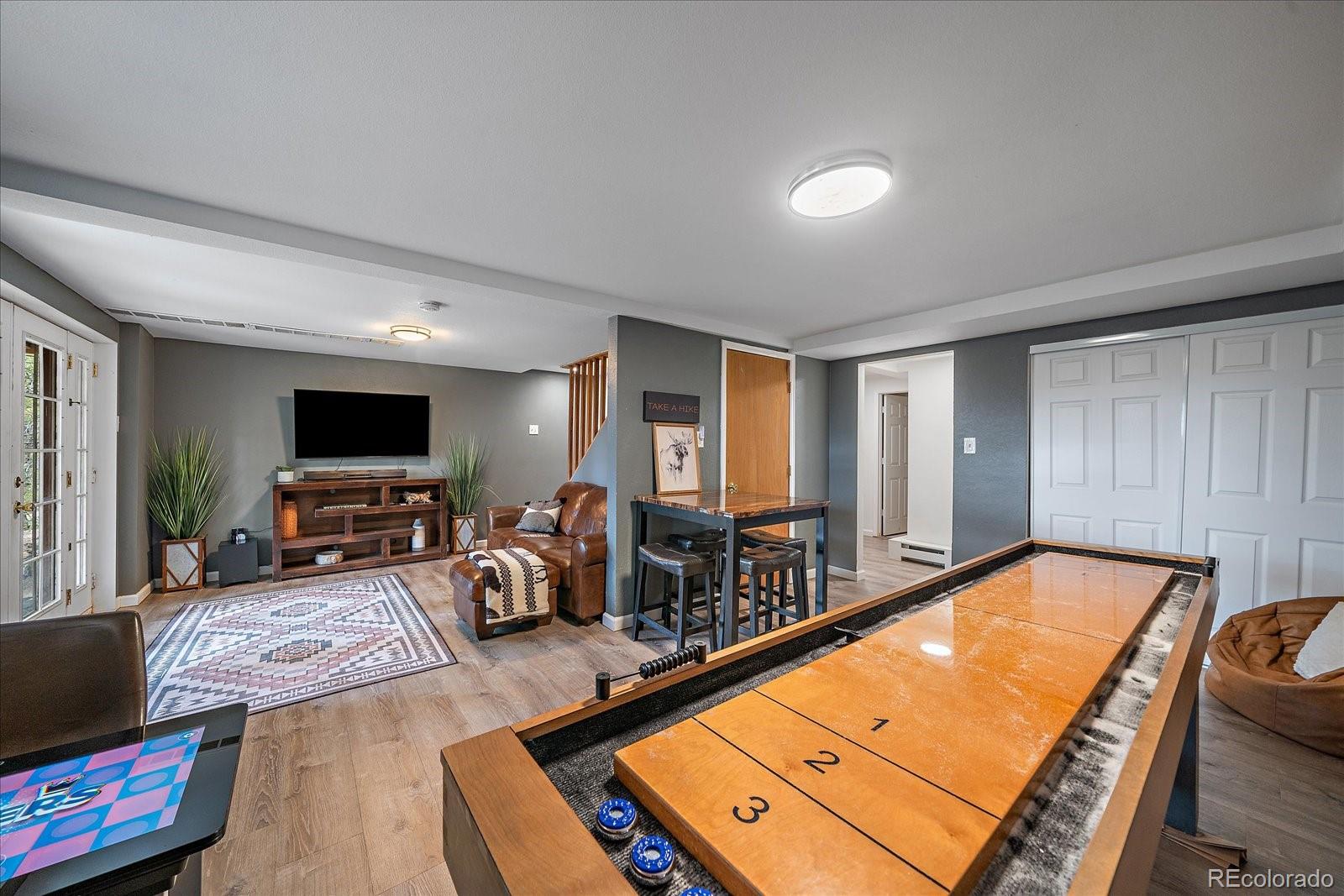 136 Nebraska Drive Idaho Springs, CO 80452 - Photo 23 of 29 a living room with furniture pool table and a flat screen tv