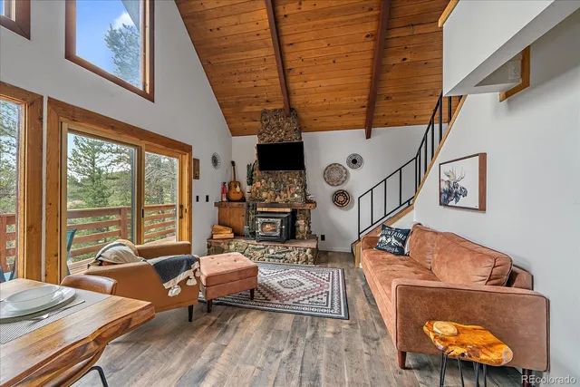 a living room with furniture and a floor to ceiling window