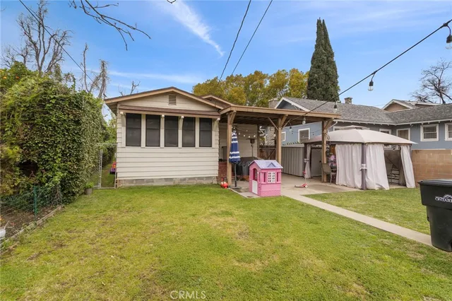 a view of a house with a backyard porch and sitting area