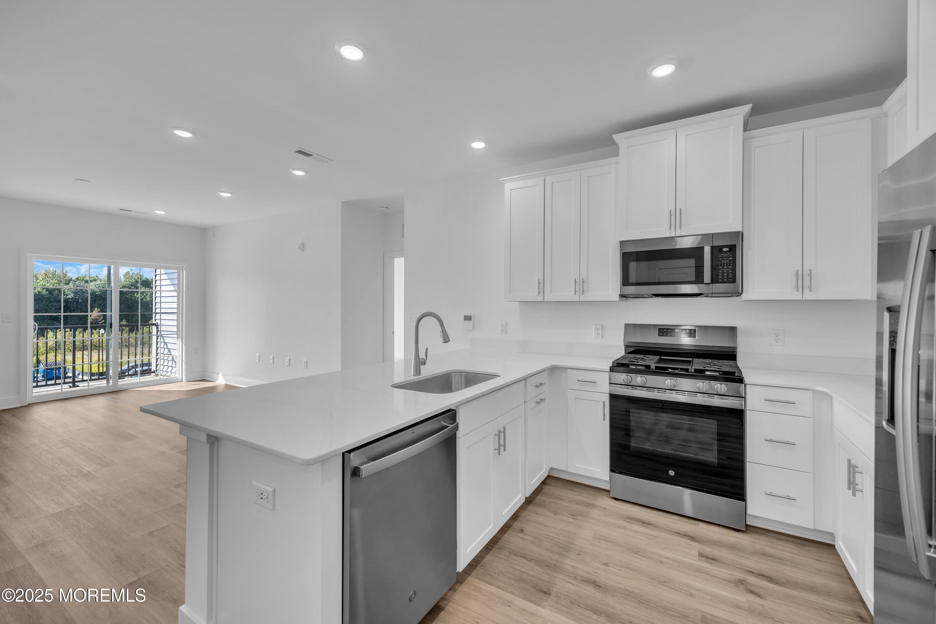 28311 Radford Court, Unit 2829 Monroe Township, NJ 08831 - Photo 11 of 29 a kitchen with stainless steel appliances granite countertop a sink stove and microwave