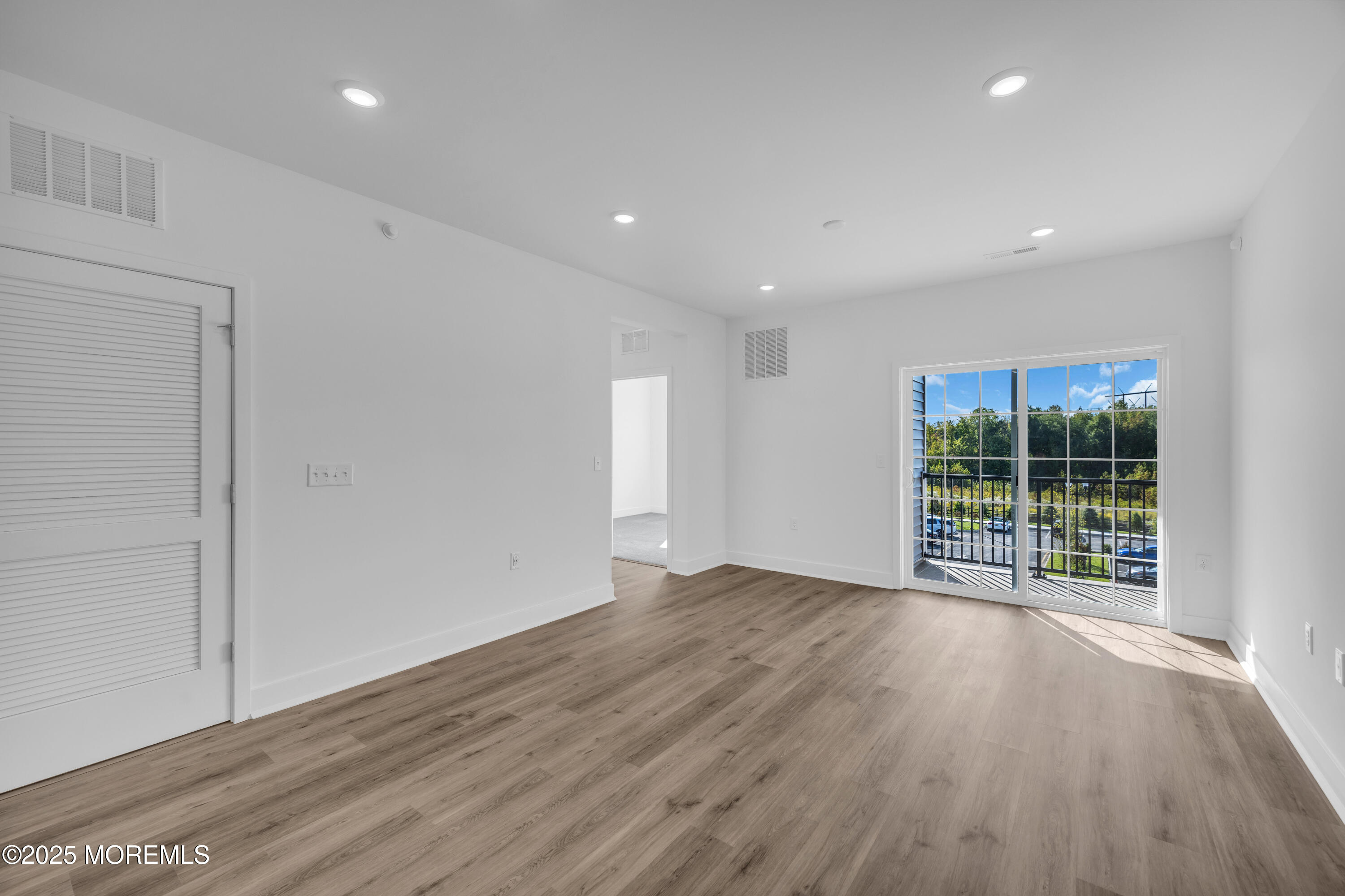 28311 Radford Court, Unit 2829 Monroe Township, NJ 08831 - Photo 15 of 29 a view of an empty room with wooden floor and a window