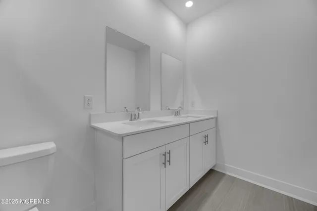 a bathroom with a sink toilet and a mirror