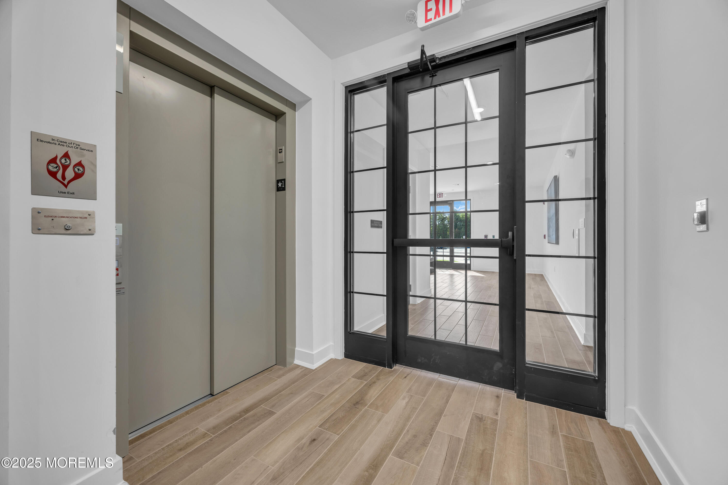 28311 Radford Court, Unit 2829 Monroe Township, NJ 08831 - Photo 6 of 29 a view of empty room with wooden floor and windows