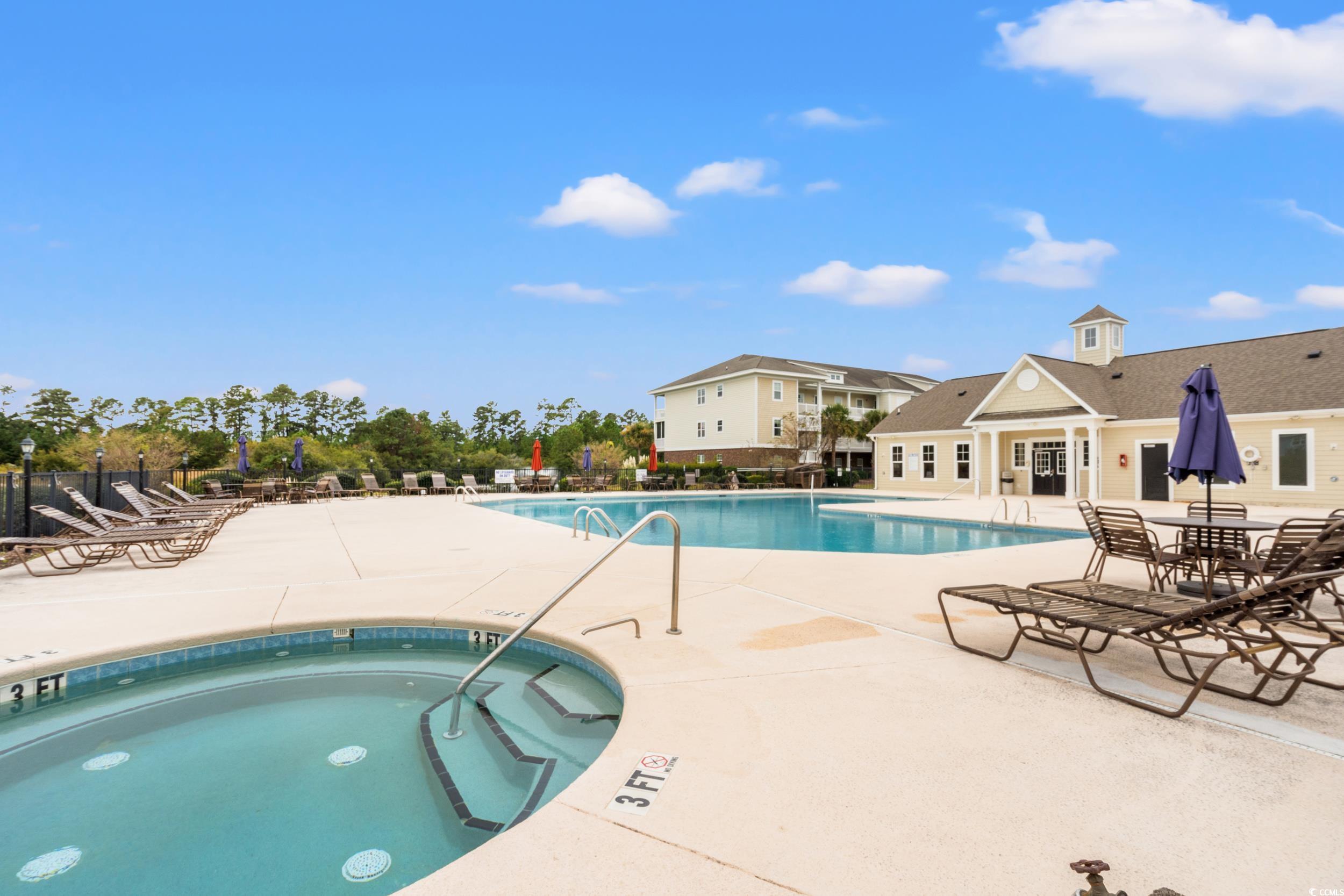 322 Kiskadee Loop, Unit 12E Conway, SC 29526 - Photo 18 of 36 Community pool featuring a patio area and a community hot tub