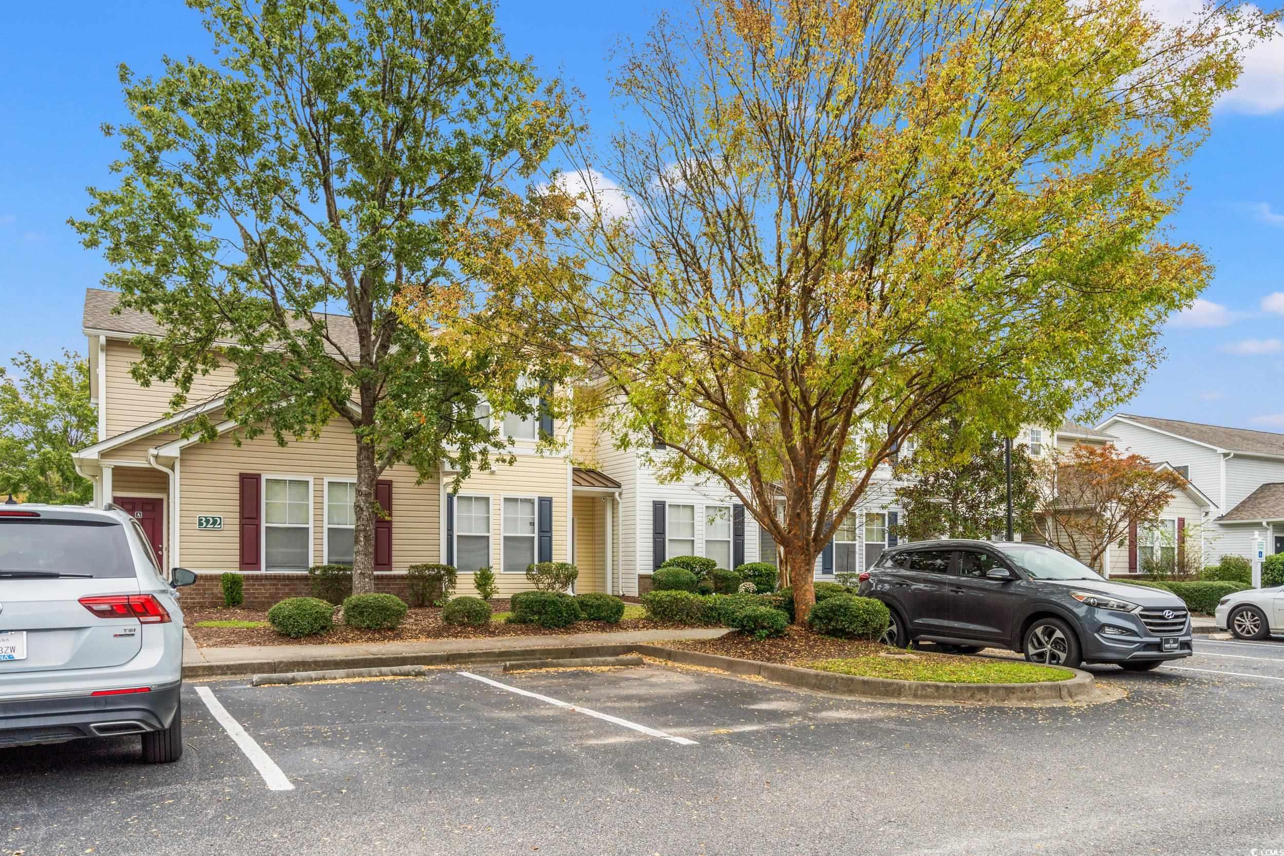 322 Kiskadee Loop, Unit 12E Conway, SC 29526 - Photo 2 of 36 View of property hidden behind natural elements featuring uncovered parking