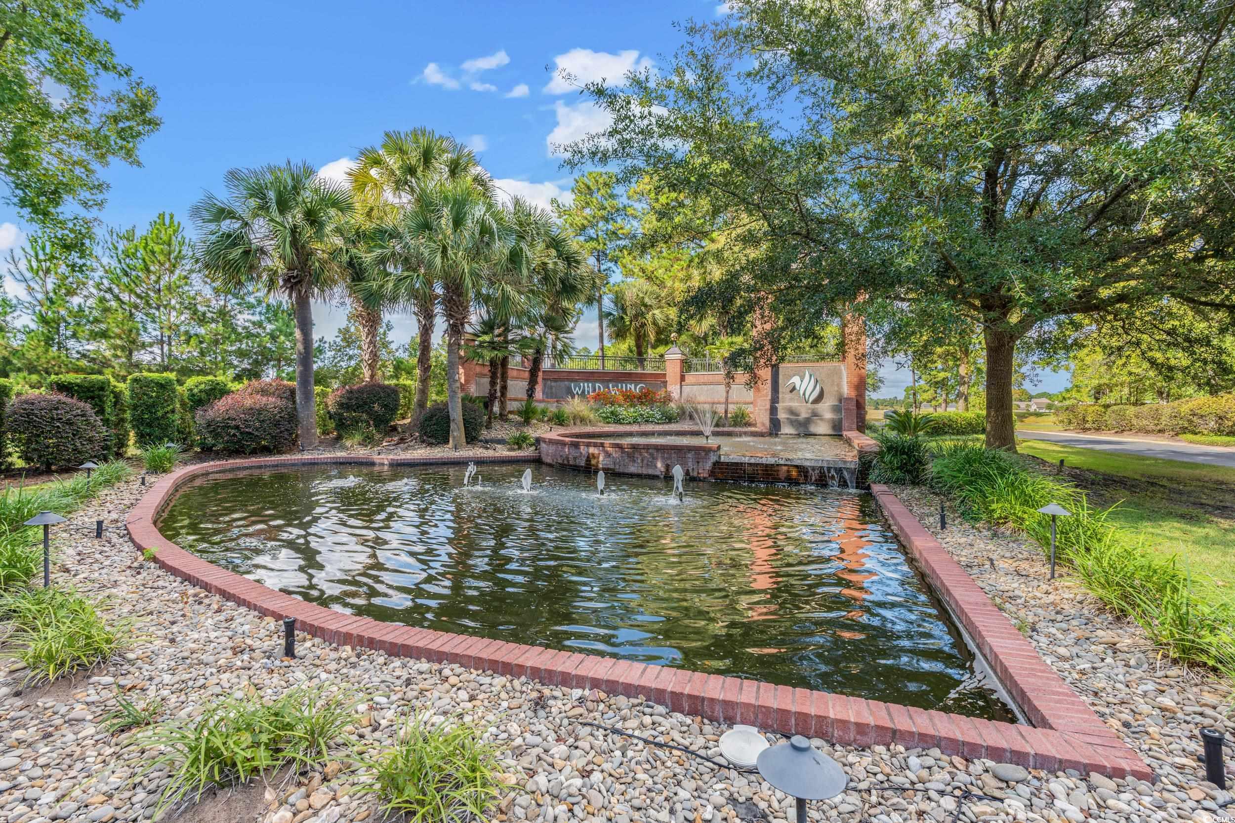 322 Kiskadee Loop, Unit 12E Conway, SC 29526 - Photo 22 of 36 View of home's community featuring a small pond