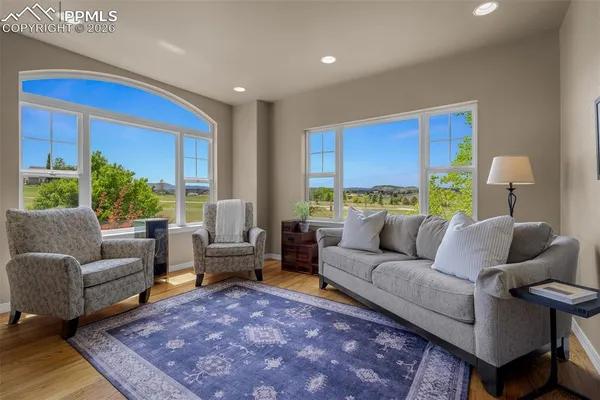 a living room with furniture rug and a table