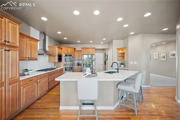 a large kitchen with kitchen island granite countertop a dining table and chairs