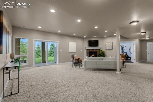 a living room with furniture a fireplace and a flat screen tv