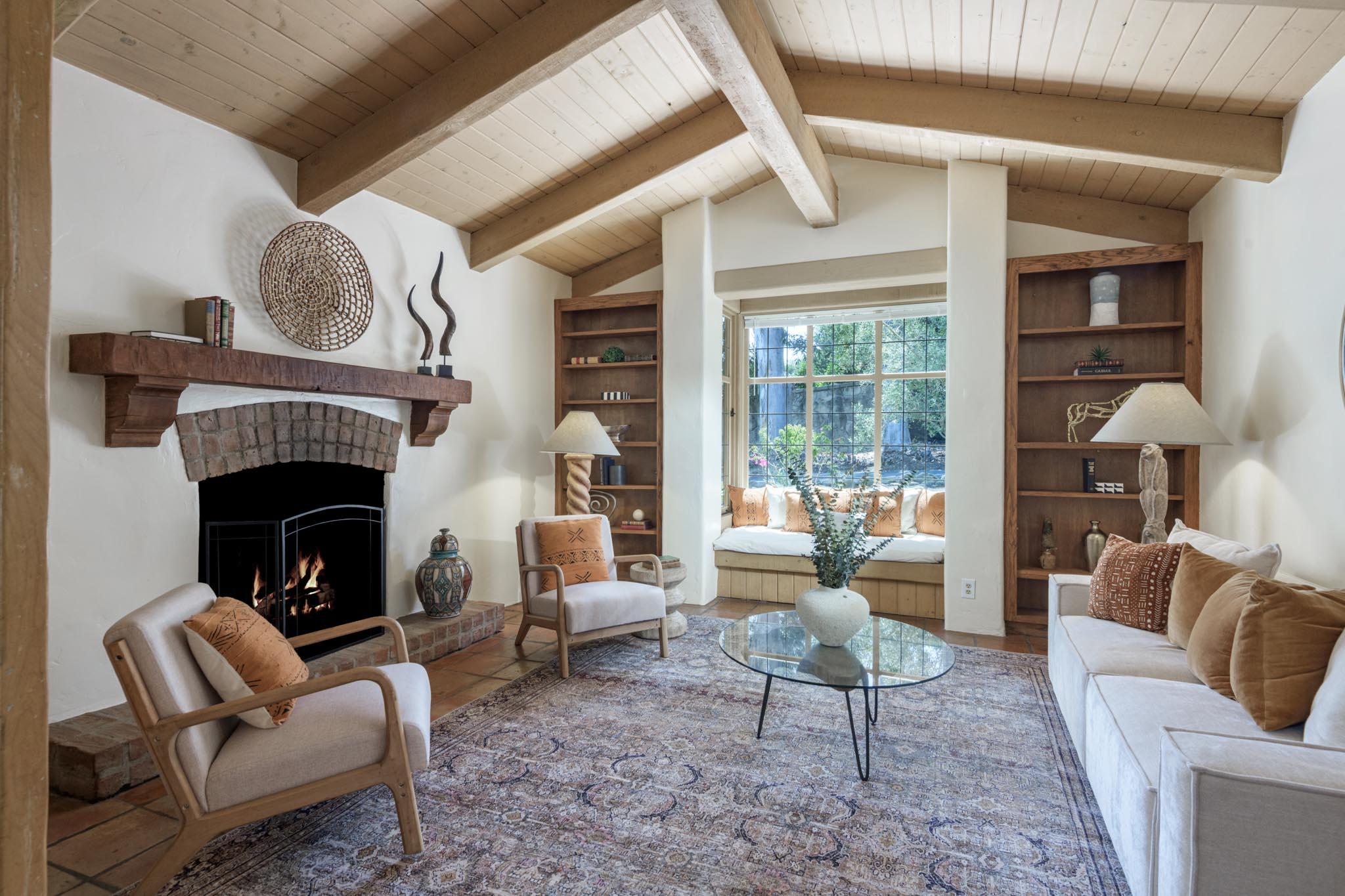 601 San Ysidro Road Santa Barbara, CA 93108 - Photo 11 of 31 a living room with furniture a fireplace and a large window
