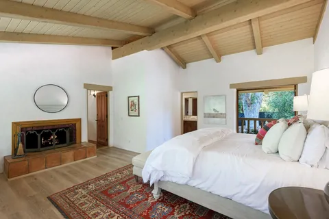 a bedroom with a bed and a fireplace