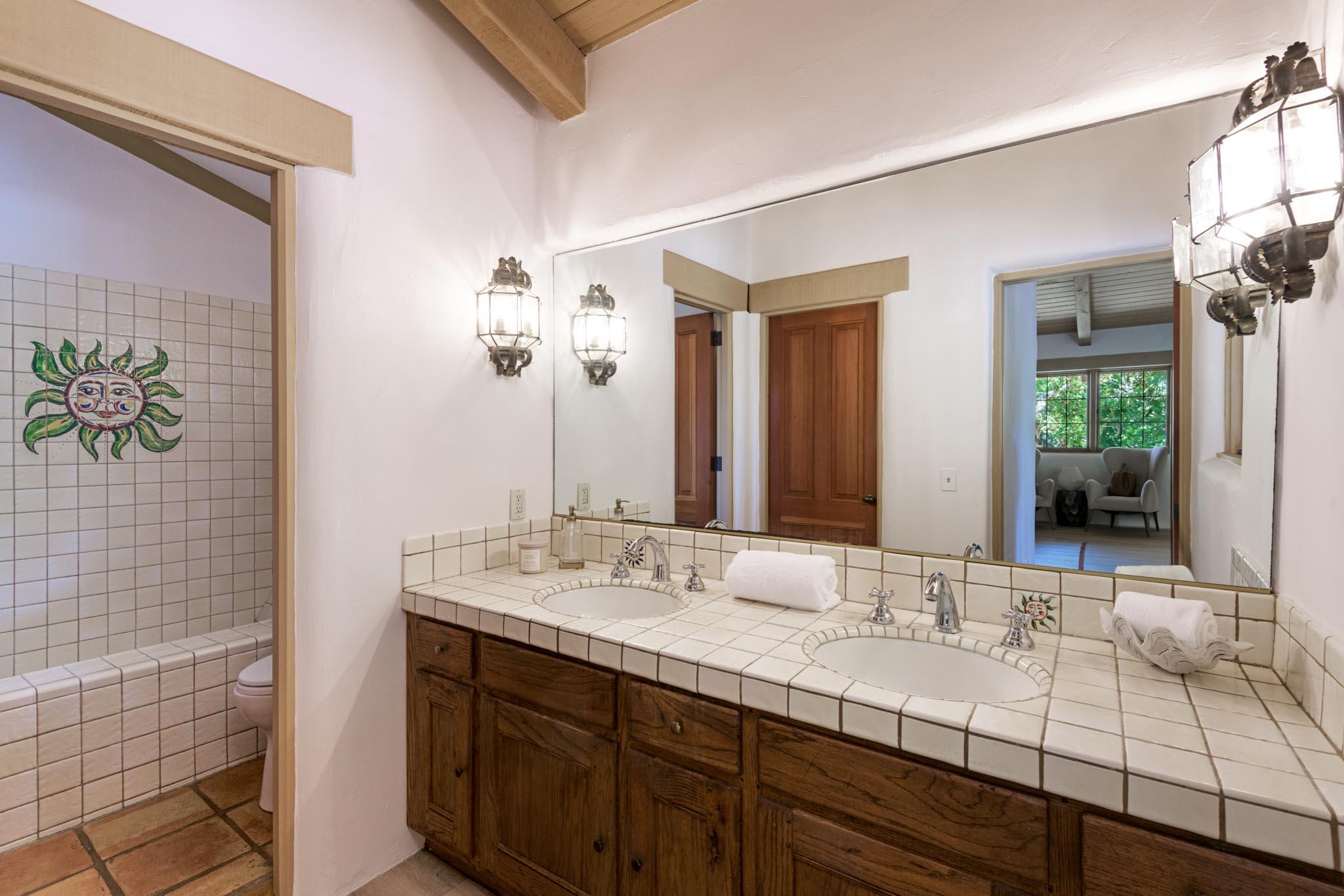 601 San Ysidro Road Santa Barbara, CA 93108 - Photo 16 of 31 a bathroom with a sink and a mirror