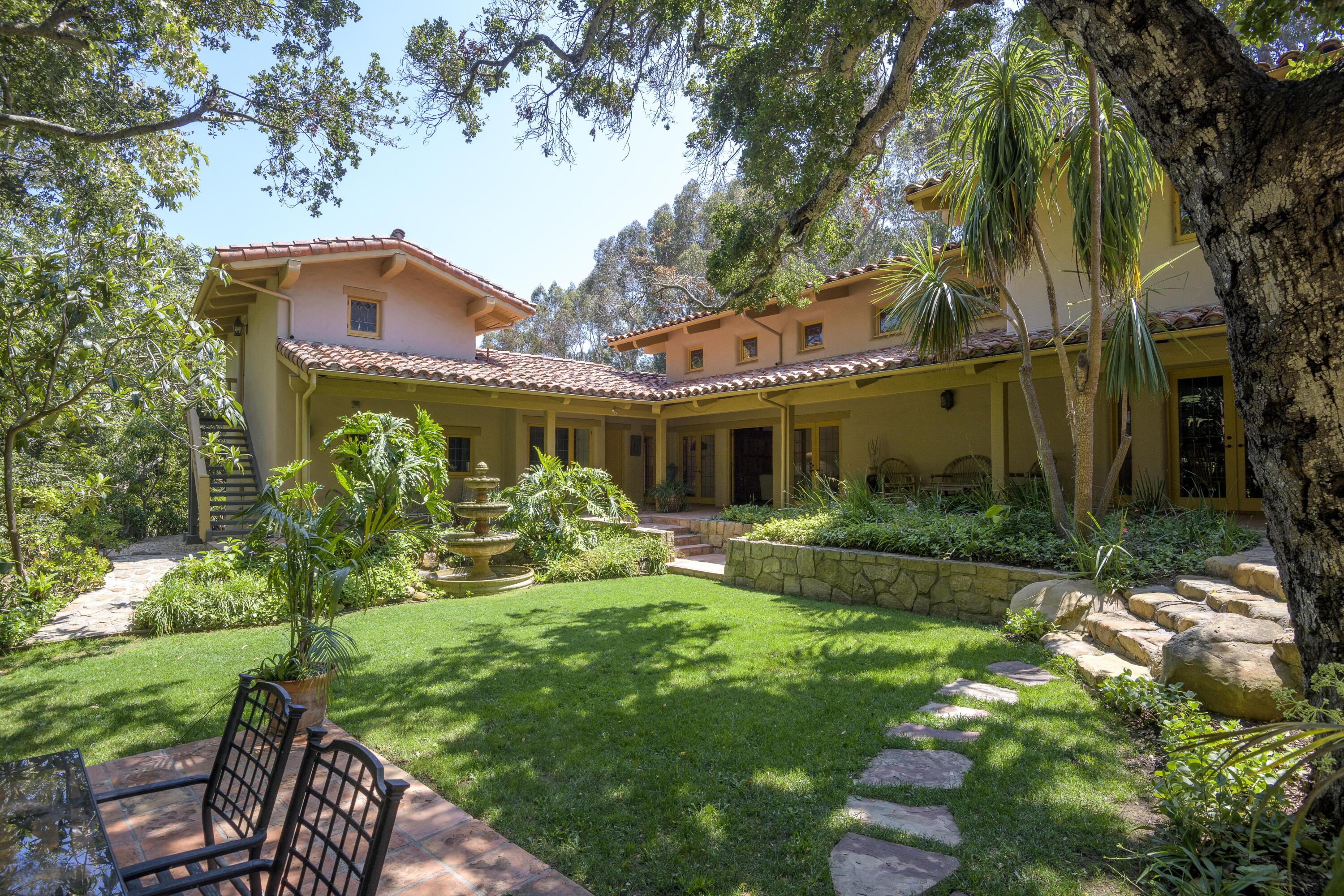 601 San Ysidro Road Santa Barbara, CA 93108 - Photo 2 of 31 a front view of a house with yard and green space