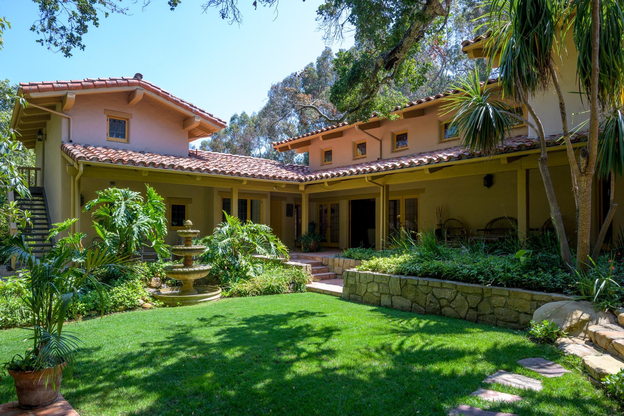 601 San Ysidro Road Santa Barbara, CA 93108 - Photo 21 of 31 a view of a house with a yard potted plants and a table
