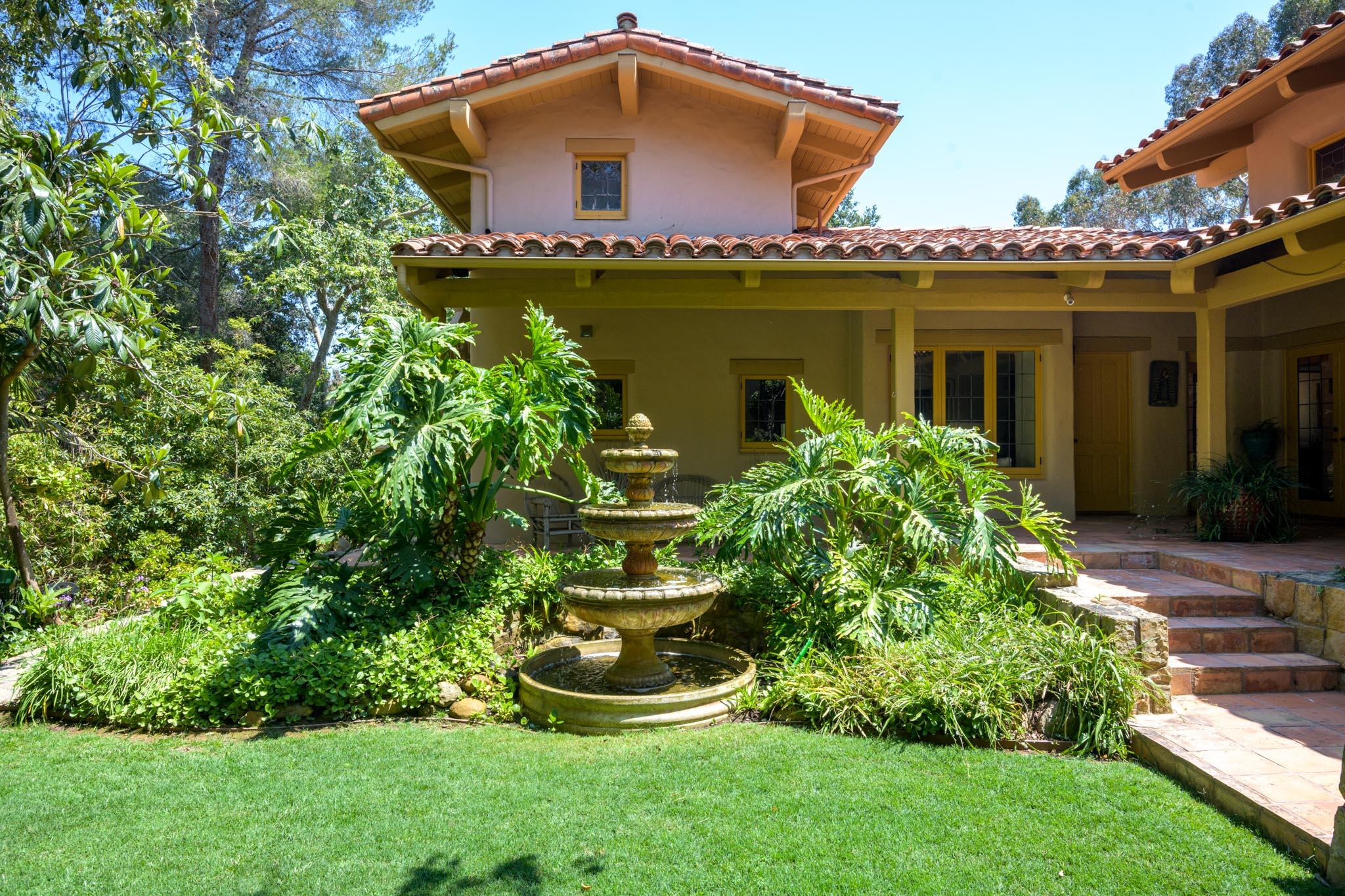 601 San Ysidro Road Santa Barbara, CA 93108 - Photo 22 of 31 a front view of a house with a yard and potted plants