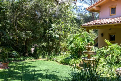 a front view of a house with garden