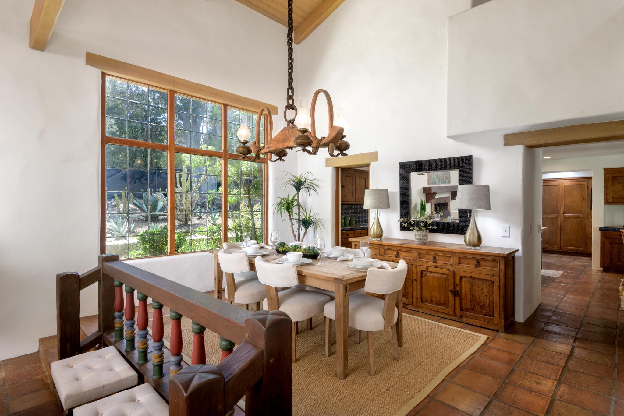 601 San Ysidro Road Santa Barbara, CA 93108 - Photo 6 of 31 a view of a dining room with furniture a chandelier and wooden floor