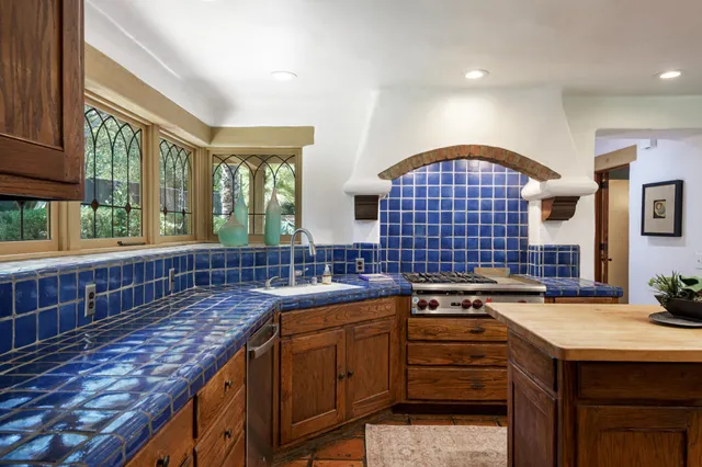 a kitchen with kitchen island a sink stove and cabinets