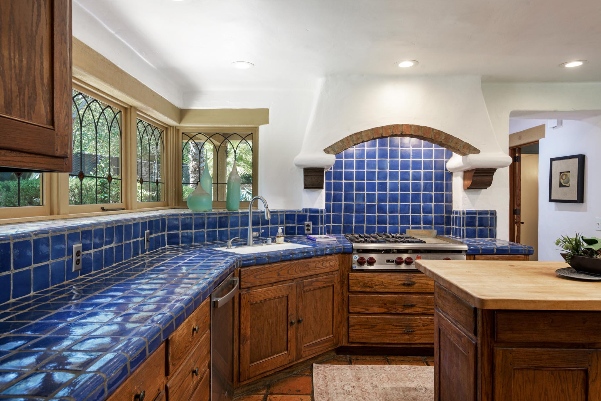 601 San Ysidro Road Santa Barbara, CA 93108 - Photo 8 of 31 a kitchen with kitchen island a sink stove and cabinets