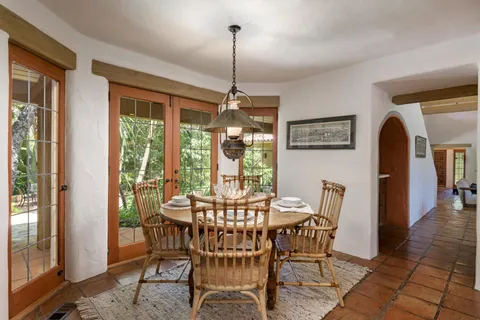 a dining room with furniture window and outside view