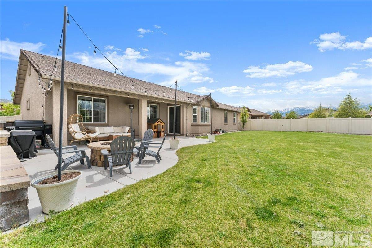 2265 Renzo Way Reno, NV 89521 - Photo 1 of 24 a view of a patio with table and chairs potted plants with wooden fence