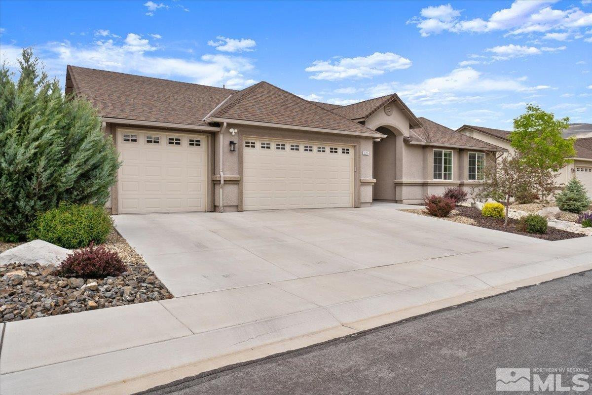 2265 Renzo Way Reno, NV 89521 - Photo 3 of 24 a front view of a house with a yard and garage