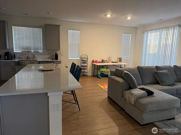 a kitchen with stainless steel appliances granite countertop a refrigerator a stove a sink and a refrigerator