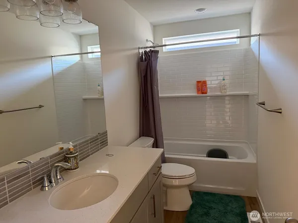 a bathroom with a shower and a toilet