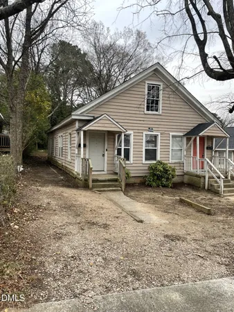 a view of a yard with a house and wooden fence