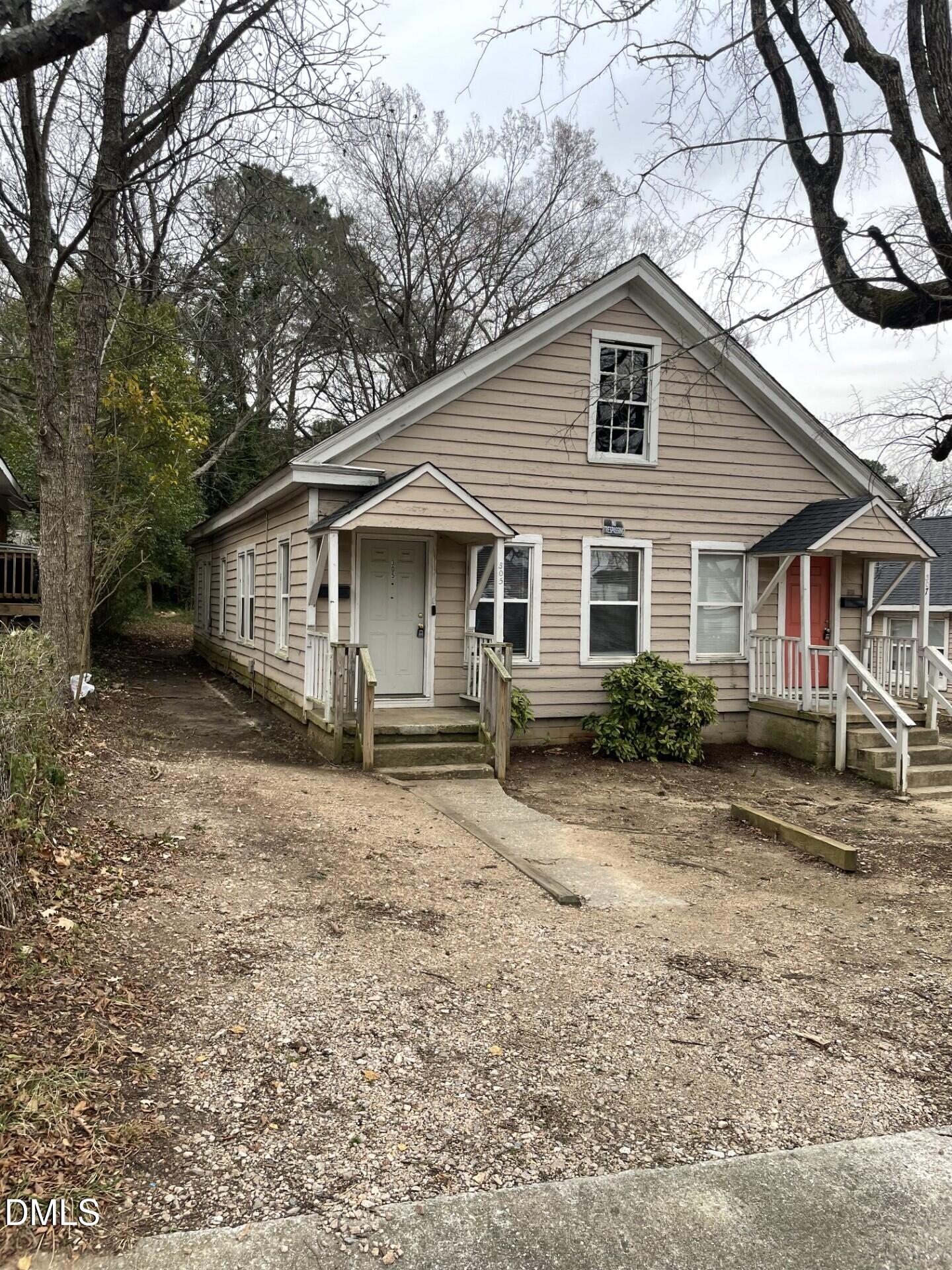 305 Kennedy Street Raleigh, NC 27610 - Photo 1 of 13 a view of a yard with a house and wooden fence