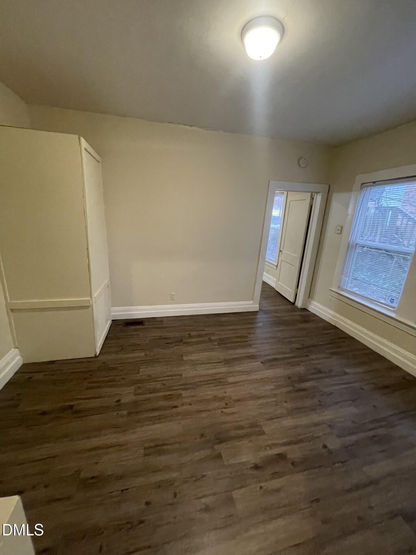 305 Kennedy Street Raleigh, NC 27610 - Photo 3 of 13 a view of an empty room with wooden floor