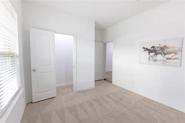 an empty room with windows and closet
