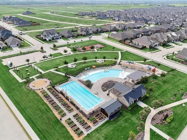 an aerial view of a residential houses with outdoor space and street view