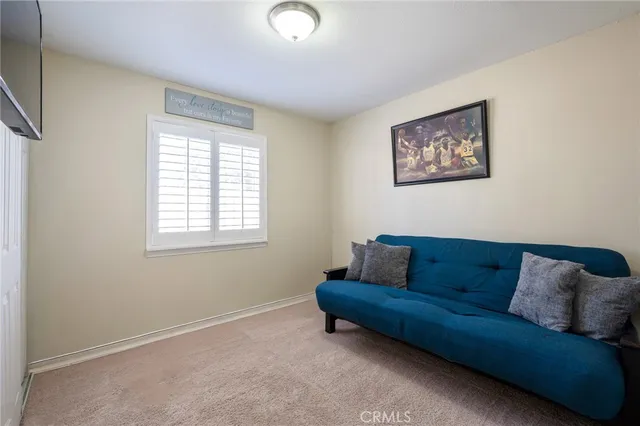 a blue couch sitting in a living room with a couch