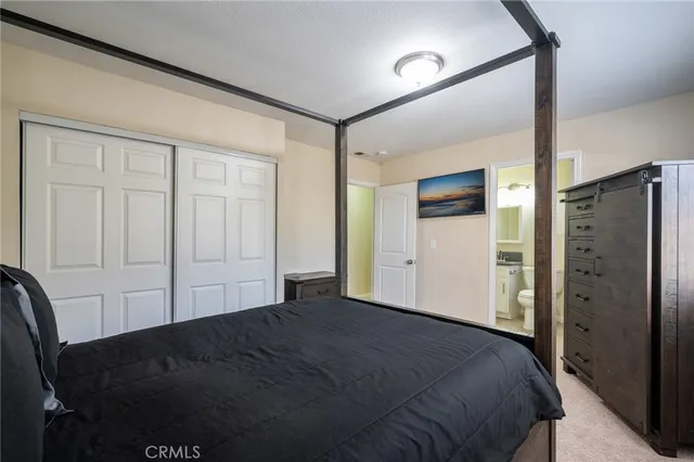a bedroom with a bed and cabinets