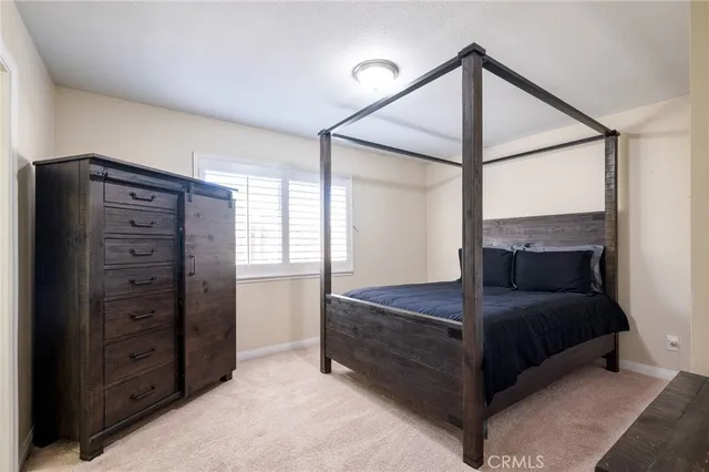 a bedroom with a bed and a mirror