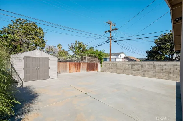 a view of a house with a yard and potted plants