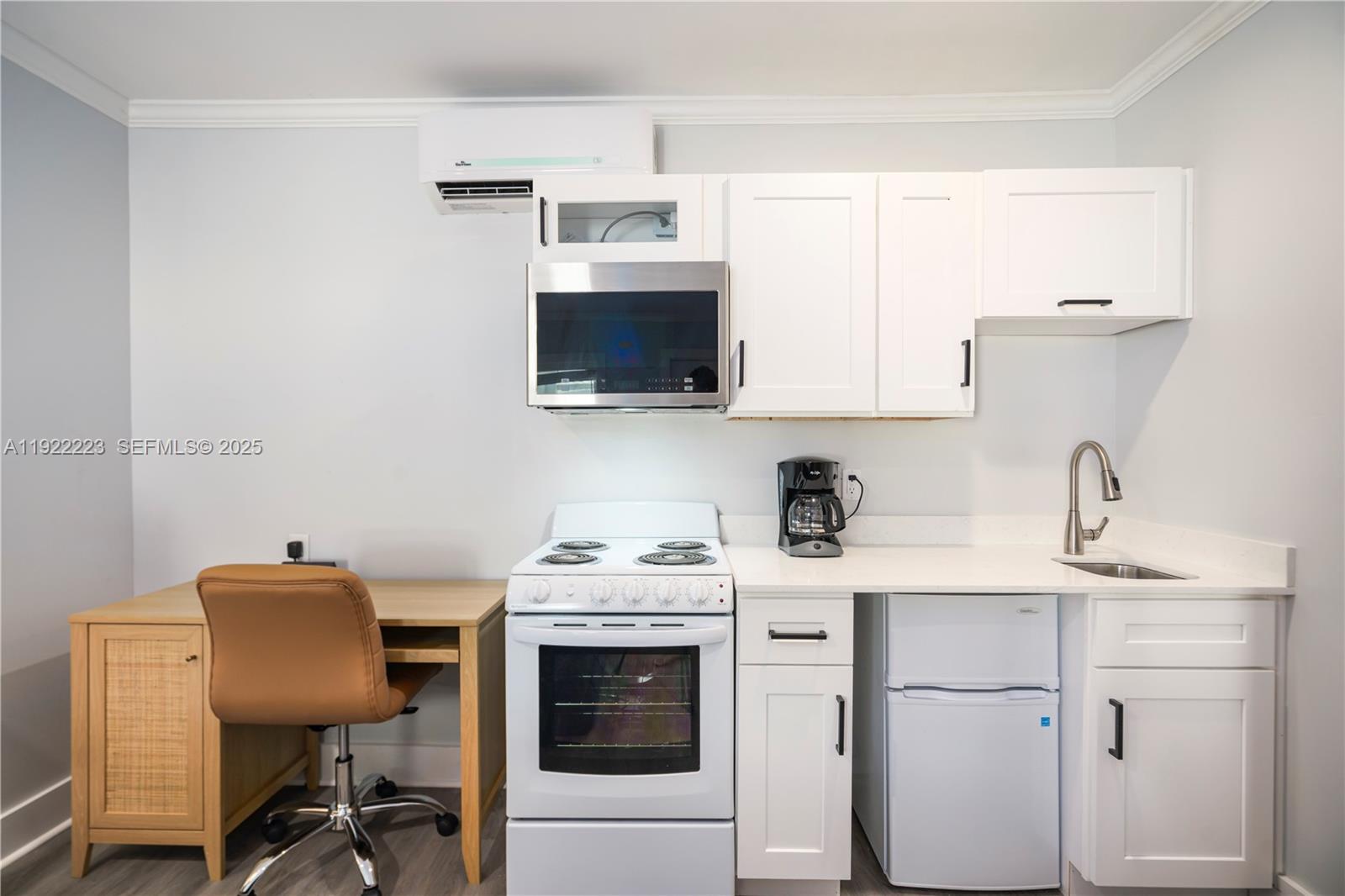 17784 Front Beach Road, Unit 10 Panama City, FL 32413 - Photo 7 of 12 a view of a workspace with furniture and a kitchen