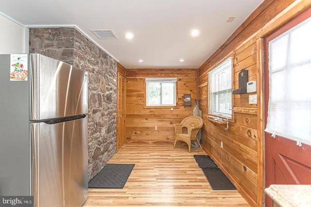 a living room with furniture a rug and a floor to ceiling window