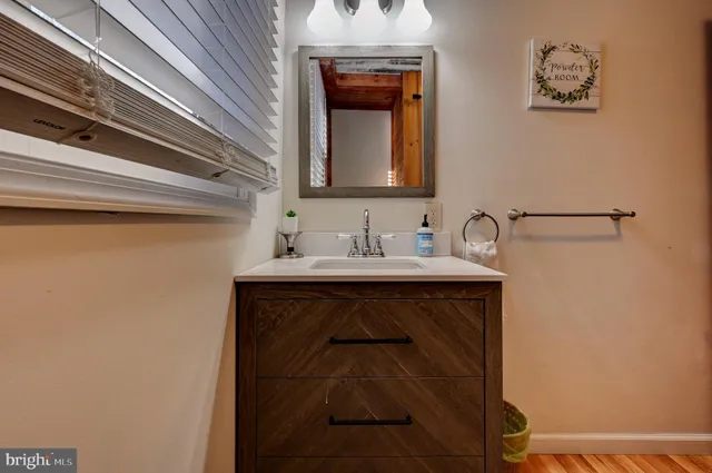 a bathroom with a sink a mirror and a shower