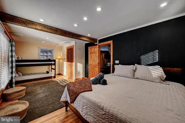 a living room with furniture flat screen tv and a book shelf