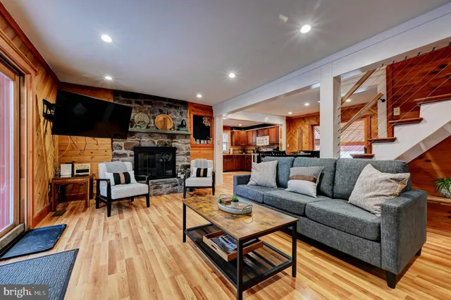 a living room with fireplace furniture and a flat screen tv