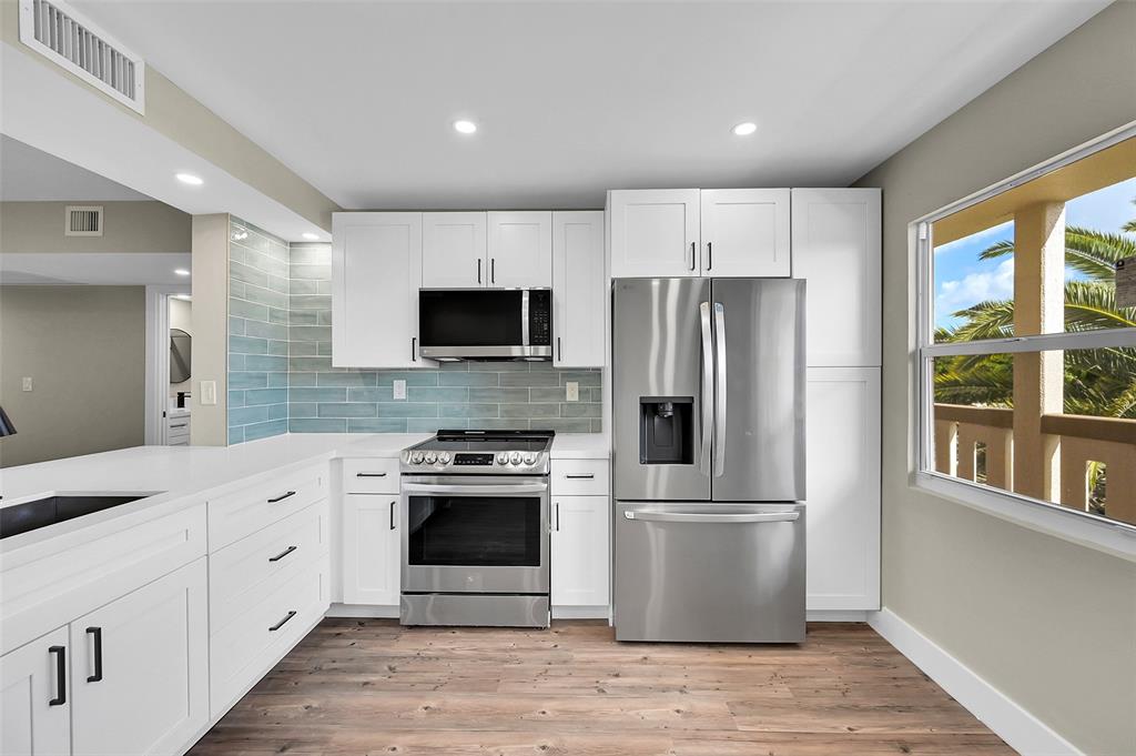 a kitchen with a refrigerator stove and sink