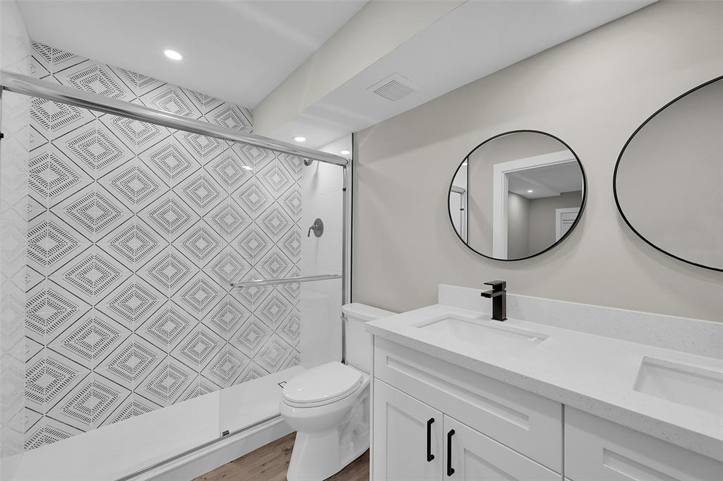 Lucaya Village Condominiums Coconut Creek, FL 33066 - Photo 14 of 28 a bathroom with a sink mirror a toilet and a shower