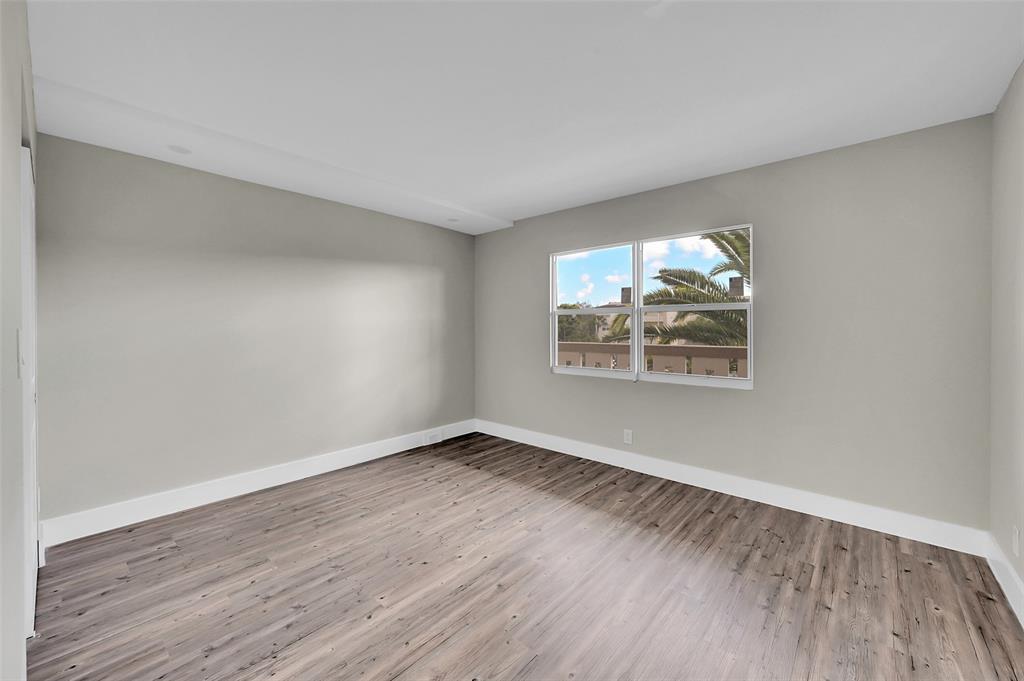 Lucaya Village Condominiums Coconut Creek, FL 33066 - Photo 18 of 28 an empty room with wooden floor and windows