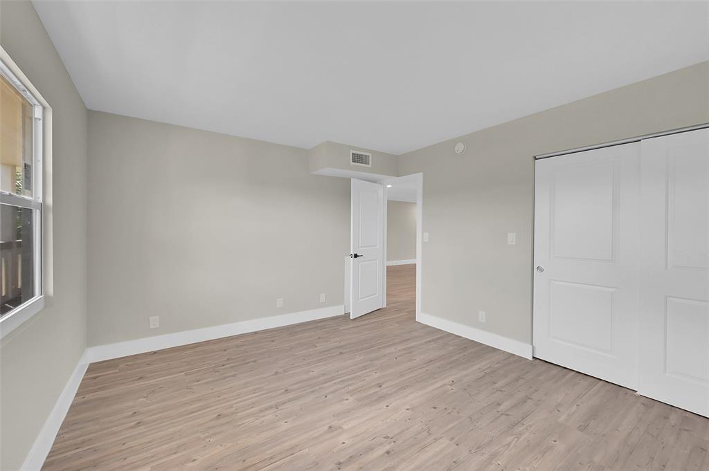 Lucaya Village Condominiums Coconut Creek, FL 33066 - Photo 19 of 28 a view of an empty room with wooden floor and a window
