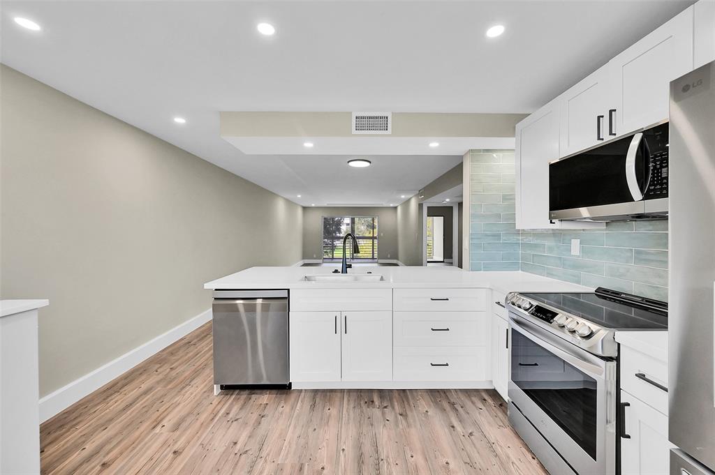 Lucaya Village Condominiums Coconut Creek, FL 33066 - Photo 2 of 28 a kitchen with a stove a sink and a microwave