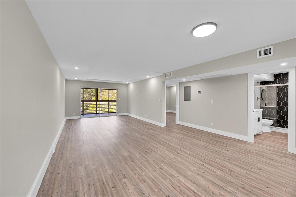 Lucaya Village Condominiums Coconut Creek, FL 33066 - Photo 22 of 28 a view of an empty room with wooden floor and a window